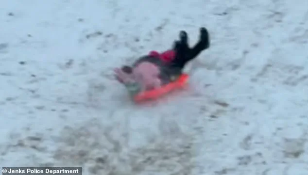 Viral Video Sparks Concern and Laughter as Jenks Officer's Sled Ride Turns Chaotic During Snowstorm