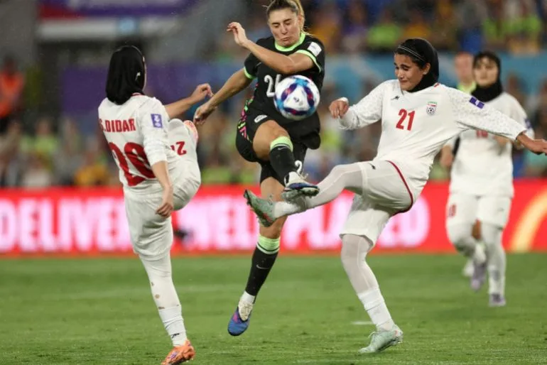 Iranian Women's Football Team Raises Hands in Salute During Anthem as Crowd Boos and Waves Pre-1979 Flag Amid Violence in Iran